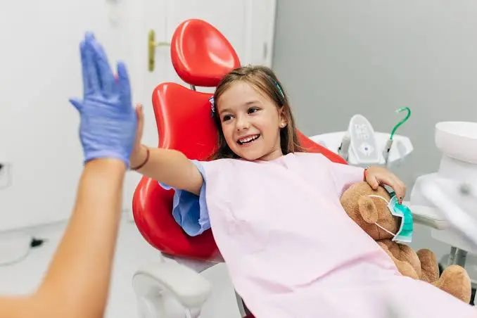 Pediatric dentist treating a child patient, serving Thalaghattapura